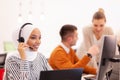 African american muslim girl with hijab and headset in a modern office. Customer service call center Royalty Free Stock Photo