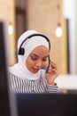 African american muslim girl with hijab and headset in a modern office. Customer service call center Royalty Free Stock Photo
