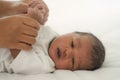 African american new born baby lying on white bed