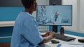 African american nurse using video call for conversation with doctor