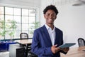 African-American office worker holding tablet, looking at camera Royalty Free Stock Photo