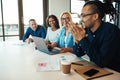 African American office worker laughing with colleagues in a mee Royalty Free Stock Photo