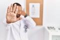 African american optician man standing by eyesight test covering eyes with hands and doing stop gesture with sad and fear Royalty Free Stock Photo