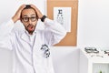 African american optician man standing by eyesight test crazy and scared with hands on head, afraid and surprised of shock with Royalty Free Stock Photo