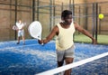 African american paddle tennis player preparing to hit ball on court Royalty Free Stock Photo