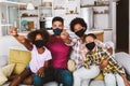 African American parents and cute small kids wearing protective masks at home. Royalty Free Stock Photo