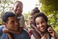 African American parents giving children piggyback rides