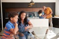 African American Parents Helping Children Studying Homework On Digital Tablets In Kitchen Royalty Free Stock Photo