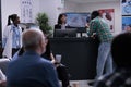 African american patient talking with private clinic receptionist registering for doctor appointment