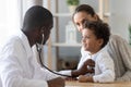 African American pediatrician listening to child lung and heart sound Royalty Free Stock Photo