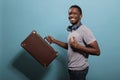 African american person holding suitcase baggage to go on trip Royalty Free Stock Photo