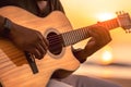 African american person\'s hands playing acoustic guitar on sandy beach at sunset time. Playing music concept, neural network