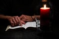 African American Person Studying the Bible in Dark Room Royalty Free Stock Photo