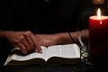 African American Person Studying the Bible in Dark Room Royalty Free Stock Photo