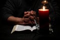 African American Person Studying the Bible in Dark Room Royalty Free Stock Photo