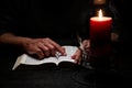 African American Person Studying the Bible in Dark Room Royalty Free Stock Photo