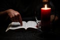 African American Person Studying the Bible in Dark Room Royalty Free Stock Photo