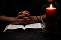 African American Person Studying the Bible in Dark Room Royalty Free Stock Photo