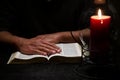 African American Person Studying the Bible in Dark Room Royalty Free Stock Photo