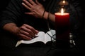 African American Person Studying the Bible in Dark Room Royalty Free Stock Photo