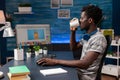 African american photographer drinking coffee while editing digital photography