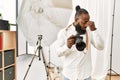 African american photographer man working at photography studio tired rubbing nose and eyes feeling fatigue and headache