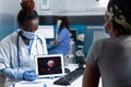 African american physician doctor holding tablet computer