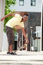 An African American picking up his skateboard Royalty Free Stock Photo