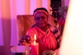 African american plump fortune-teller in ethnic adornments looking serious