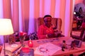 African american plump fortune-teller in ethnic adornments reading cards Tarot