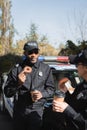 African american police officer with doughnut Royalty Free Stock Photo