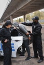 African american policeman arresting hooded offender