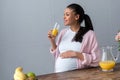 african american pregnant woman with glass of orange juice Royalty Free Stock Photo