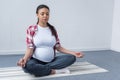 african american pregnant woman practicing yoga
