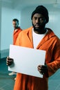 african american prisoner holding blank placard and looking