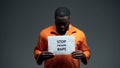 African-american prisoner holding stop prison rape sign, sexual harassment
