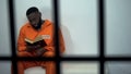 African-american prisoner reading holy bible, convicted sinner, religion