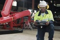 Black engineer test and control robotic arm in mechanical manufacturing factory