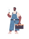 African american professional repairman in uniform holding screwdriver and toolbox home maintenance repair service