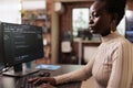 African american programmer typing big data code on compute