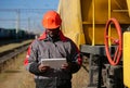 African american railway man with tablet pc at freight train terminal Royalty Free Stock Photo