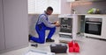 African American repairman fixing dishwasher appliance Royalty Free Stock Photo