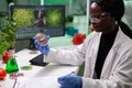 African american researcher looking at petri dish with vegan beef Royalty Free Stock Photo