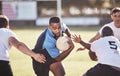 African american rugby player running away from an opponent while attempting to score a try during a rugby match outside Royalty Free Stock Photo