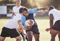 African american rugby player running away from an opponent while attempting to score a try during a rugby match outside Royalty Free Stock Photo