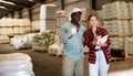 African American salesman helping young customer choose materials