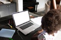 African american schoolgirl with afro hair attending online lecture over laptop on table at home Royalty Free Stock Photo