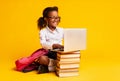 African American Schoolgirl Sitting At Laptop Doing Homework, Studio Shot Royalty Free Stock Photo