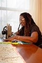 African-American Woman Creates a Quilt on Antique Sewing Machine