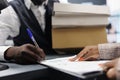 African american shopaholic man signing store receipt